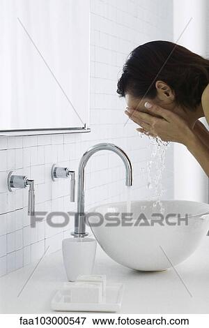 "Woman leaning over bathroom sink washing face, side view" View Large Photo Image Stock Photo - "Woman leaning over bathroom sink washing face, side view". Fotosearch