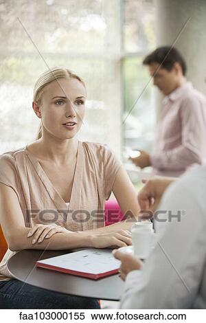 Stock Photography - Woman meeting with colleague in cafe. Fotosearch