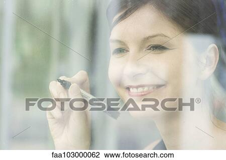 Woman preparing to write on window with marker View Large Photo Image Stock Image - Woman preparing to write on window with marker. Fotosearch