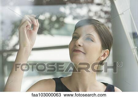 Woman preparing to write on window with marker View Large Photo Image Stock Image - Woman preparing to write on window with marker. Fotosearch