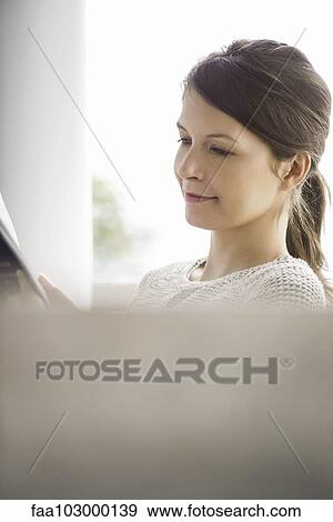 Woman reading at home View Large Photo Image Stock Photo - Woman reading at home. Fotosearch