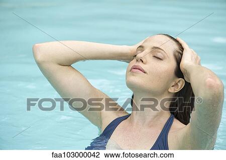 Woman relaxing in swimming pool View Large Photo Image Stock Image - Woman relaxing in swimming pool. Fotosearch