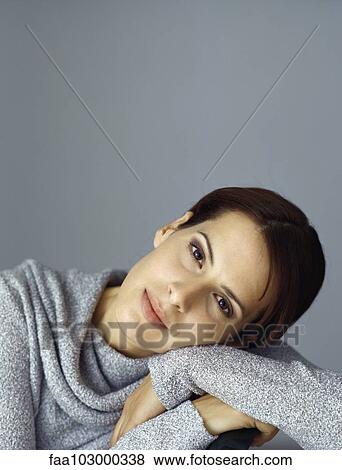 Stock Photo - "Woman resting head on arms, portrait". Fotosearch