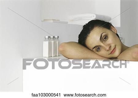 "Woman resting head on side of bathtub, smiling, portrait" View Large Photo Image Stock Image - "Woman resting head on side of bathtub, smiling, portrait". Fotosearch