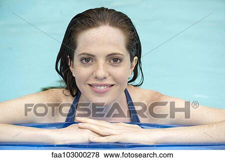 "Woman resting on float in swimming pool, portrait" View Large Photo Image Stock Photo - "Woman resting on float in swimming pool, portrait". Fotosearch