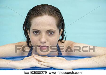 "Woman resting on float in swimming pool, portrait" View Large Photo Image Stock Photo - "Woman resting on float in swimming pool, portrait". Fotosearch