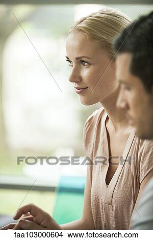 Woman smiling in meeting View Large Photo Image Picture - Woman smiling in meeting. Fotosearch