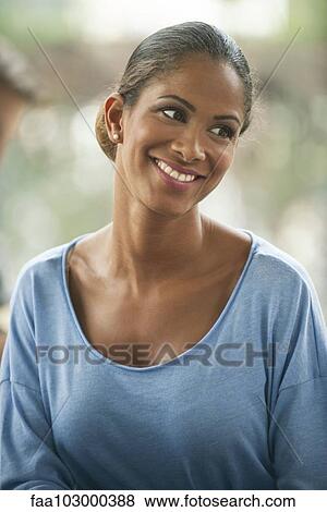 Stock Photo - "Woman smiling with head tilted, portrait". Fotosearch