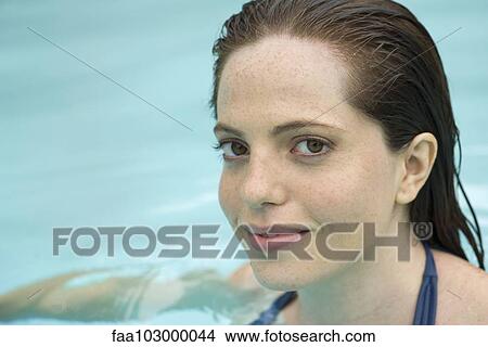 Picture - "Woman soaking in swimming pool, portrait". Fotosearch