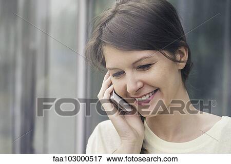 Stock Photo - Woman talking on cell phone. Fotosearch