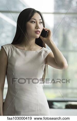 Woman using cell phone View Large Photo Image Stock Photo - Woman using cell phone. Fotosearch