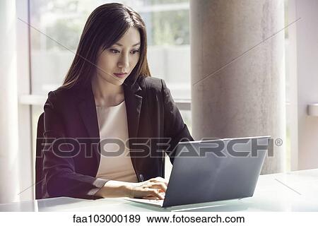 Woman using laptop computer View Large Photo Image Stock Photo - Woman using laptop computer. Fotosearch