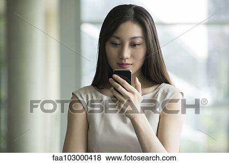 Woman using smartphone View Large Photo Image Stock Photo - Woman using smartphone. Fotosearch