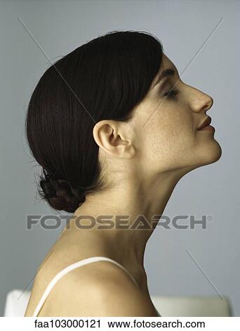Stock Image - "Woman with chignon, eyes closed, profile". Fotosearch
