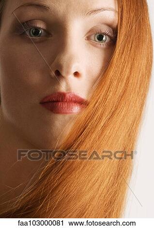Stock Image - "Woman with red hair, wearing lipstick, portrait". Fotosearch