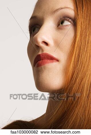"Woman with red hair, wearing lipstick, portrait" View Large Photo Image Stock Image - "Woman with red hair, wearing lipstick, portrait". Fotosearch