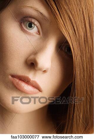 Woman's face and red hair covering one eye View Large Photo Image Stock Photo - Woman's face and red hair covering one eye. Fotosearch