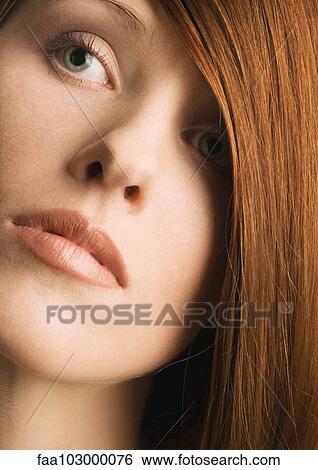 Woman's face and red hair covering one eye View Large Photo Image Stock Photograph - Woman's face and red hair covering one eye. Fotosearch