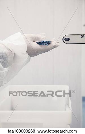 Worker catching packages of prescription drugs from conveyor belt View Large Photo Image Stock Photo - Worker catching packages of prescription drugs from conveyor belt. Fotosearch