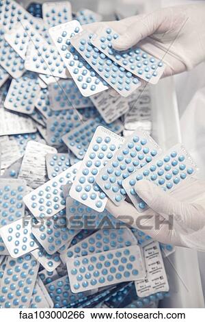 Worker inspecting pill packets View Large Photo Image Stock Photograph - Worker inspecting pill packets. Fotosearch