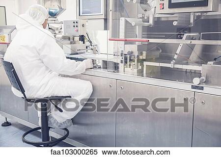 Worker monitoring industrial pill packing machinery View Large Photo Image Stock Photography - Worker monitoring industrial pill packing machinery. Fotosearch