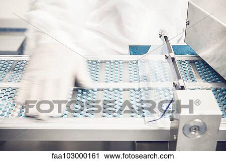 Worker monitoring pills entering blisterpack sealing equipment View Large Photo Image Stock Image - Worker monitoring pills entering blisterpack sealing equipment. Fotosearch