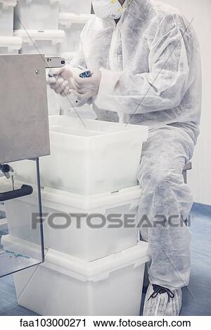 Worker packaging pill packets exiting production equipment View Large Photo Image Stock Image - Worker packaging pill packets exiting production equipment. Fotosearch