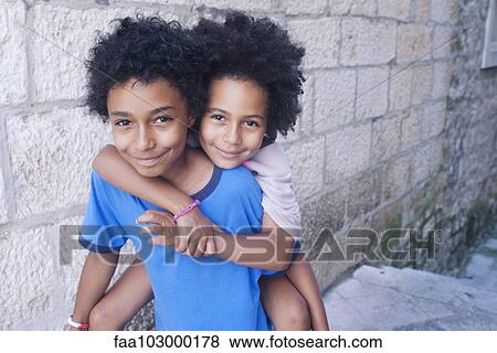 "Young siblings embracing outdoors, portrait" View Large Photo Image Stock Photo - "Young siblings embracing outdoors, portrait". Fotosearch
