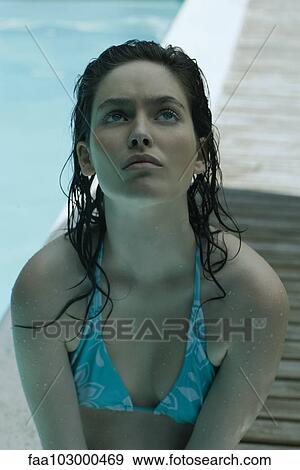 "Young woman in bikini, looking up in thought" View Large Photo Image Stock Photo - "Young woman in bikini, looking up in thought". Fotosearch