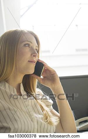 Young woman using cell phone View Large Photo Image Stock Photo - Young woman using cell phone. Fotosearch