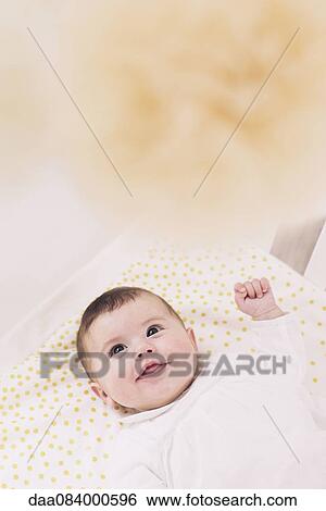 Baby lying in crib View Large Photo Image Stock Photograph - Baby lying in crib. Fotosearch