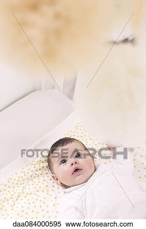 Baby lying in crib View Large Photo Image Stock Photography - Baby lying in crib. Fotosearch