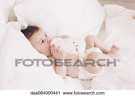 Stock Image - Baby with bottle. Fotosearch