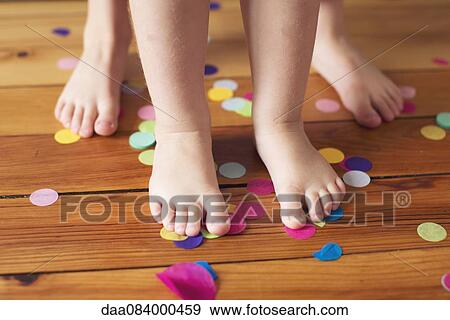 Barefeet and confetti on hardwood floor View Large Photo Image Stock Photo - Barefeet and confetti on hardwood floor. Fotosearch