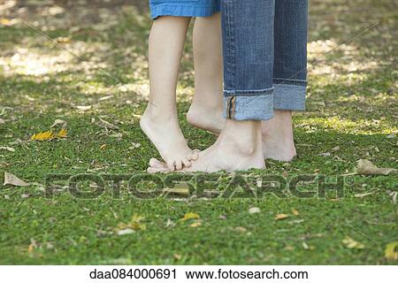 Boy standing barefoot and tiptoes on father's feet View Large Photo Image Stock Image - Boy standing barefoot and tiptoes on father's feet. Fotosearch