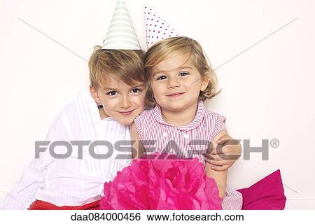 Brother and sister wearing party hats, portrait View Large Photo Image Stock Photograph - Brother and sister wearing party hats, portrait. Fotosearch