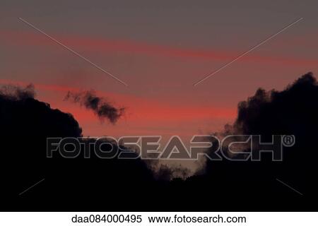 Clouds silhouetted against colorful twilight sky View Large Photo Image Stock Photography - Clouds silhouetted against colorful twilight sky. Fotosearch