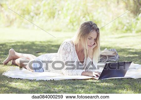 College student using laptop in park View Large Photo Image Stock Photo - College student using laptop in park. Fotosearch