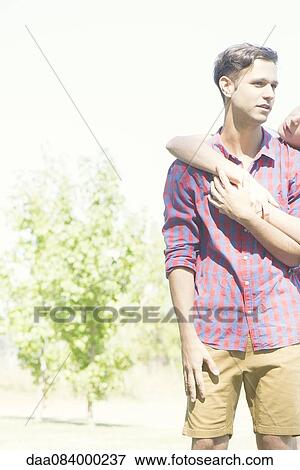 Couple embracing outdoors View Large Photo Image Stock Photo - Couple embracing outdoors. Fotosearch