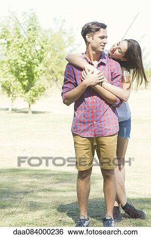Couple embracing outdoors View Large Photo Image Stock Photograph - Couple embracing outdoors. Fotosearch