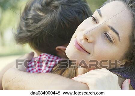 Stock Photography - Couple embracing outdoors. Fotosearch
