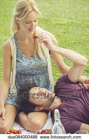 Couple having picnic together View Large Photo Image Stock Photo - Couple having picnic together. Fotosearch