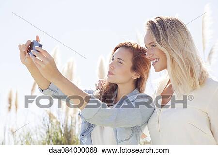 Couple posing for selfie View Large Photo Image Stock Photo - Couple posing for selfie. Fotosearch