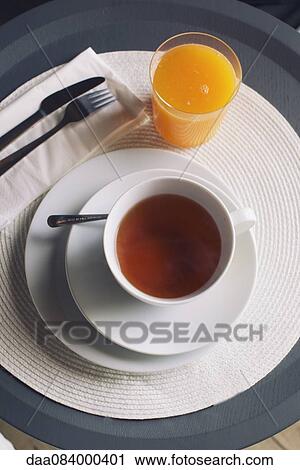 Cup of hot tea and glass of orange juice View Large Photo Image Stock Image - Cup of hot tea and glass of orange juice. Fotosearch