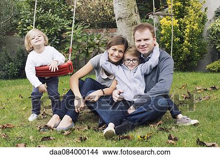 Picture - Family relaxing in backyard, portrait. Fotosearch