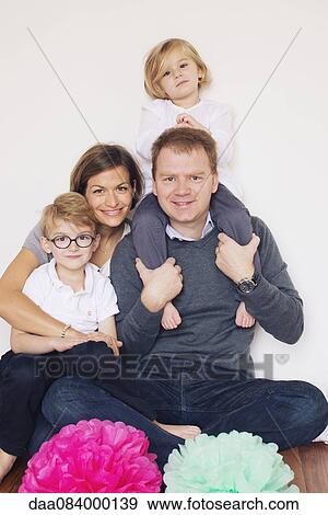 Stock Photo - Family with two children, portrait. Fotosearch