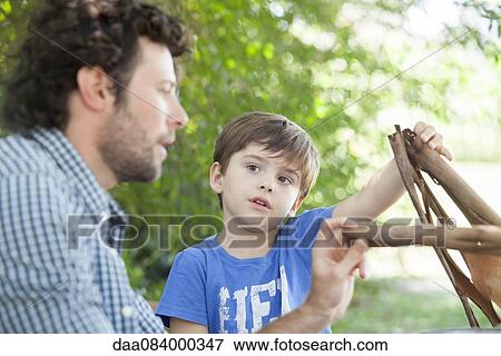 Father and son spending quality time together outdoors View Large Photo Image Stock Photo - Father and son spending quality time together outdoors. Fotosearch