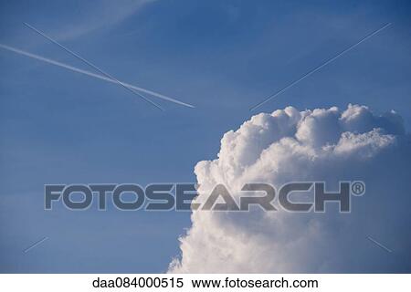 Stock Photography - Fluffy cumulus clouds against blue sky. Fotosearch