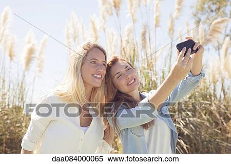 Friends posing for selfie View Large Photo Image Stock Photography - Friends posing for selfie. Fotosearch