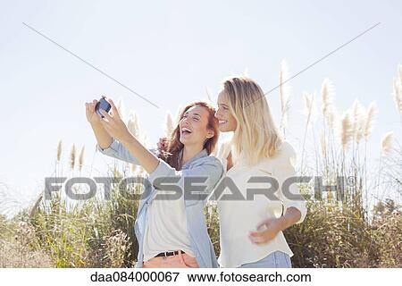 Stock Photo - Friends spending quality time together outdoors. Fotosearch